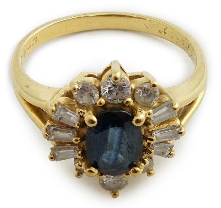 A modern 18ct gold, sapphire and diamond oval cluster ring